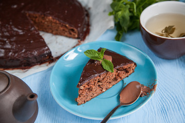 chocolate cake with tea on the wooden desk