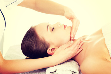 Fototapeta na wymiar Relaxed woman enjoy receiving face massage