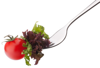 Fresh salad and cherry tomato on fork isolated on white backgrou
