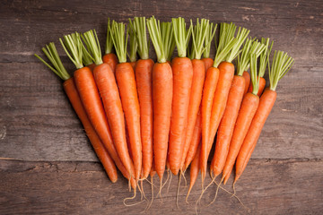 fresh carrot bunch on grungy wooden background