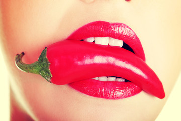 Beautiful woman with hot paprika