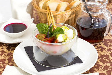 tomatoes and cheese in a glass bowl