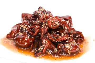 salad of octopus and cabbage leaves on a white background