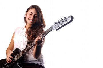 Young girl playing on bass guitar