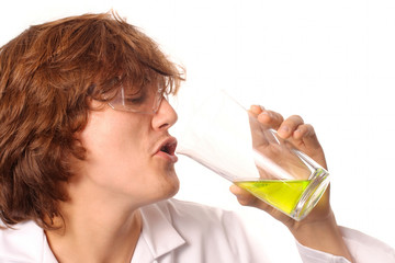 Scientist tasting liquid from a beaker