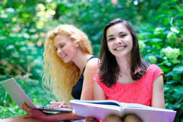 Smiling young female students at the park