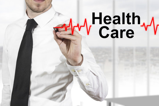 doctor drawing heartbeat line healt care