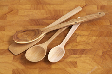 four wooden spoon on wooden plate in studio light