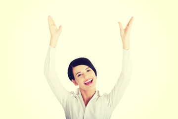 Young happy businesswoman with hands up