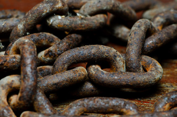 rusty chain on a wooden plank closeup