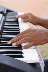 Obraz premium Old man hand playing electone, musical.