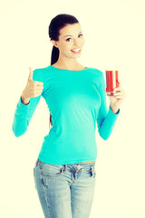 Fototapeta na wymiar Happy smiling woman drinking tomato juice