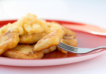 Italian delicious gnocchi on red plate