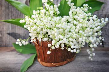 Basket with lilies of the valley (Convallaria majalis)