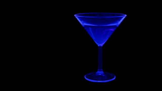 Cocktail in a club with UV (black light) and green laser