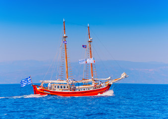 Fototapeta na wymiar Old wooden red Greek boat (Perama) in Spetses island in Greece