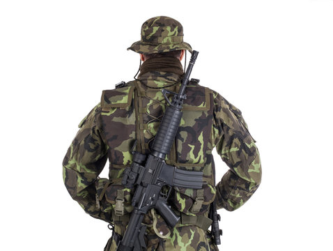 Soldier in camouflage and modern weapon M4.