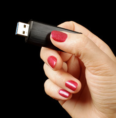 Female hand holding USB flash drive