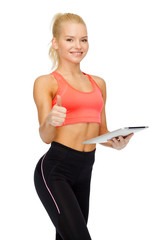 Fototapeta na wymiar smiling sporty woman with tablet pc computer