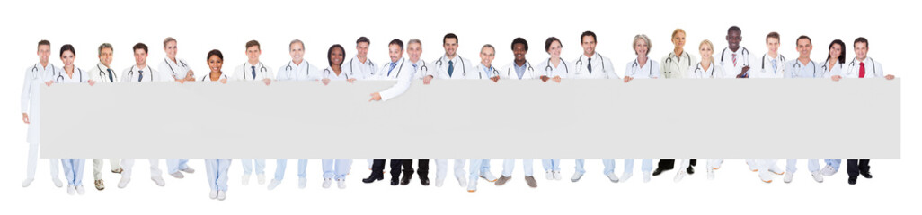 Multiethnic Doctors Holding Blank Banner