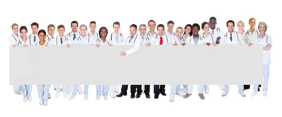 Multiethnic Doctors Holding Blank Banner
