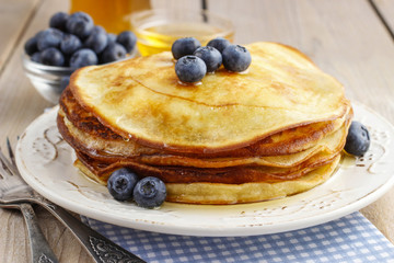 Stack of pancakes with syrup and blueberries