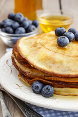 Stack of pancakes with syrup and blueberries