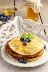 Stack of pancakes with syrup and blueberries