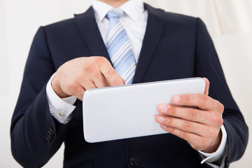 Businessman Using Digital Tablet In Office