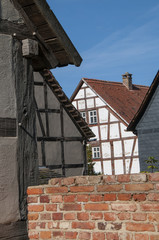 Brick wall in front of half-timbered houses
