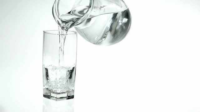 Pouring refreshing water into a glass