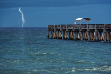 lightning strikes over the ocean
