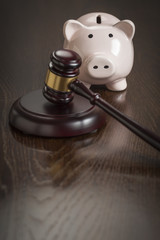 Gavel and Piggy Bank on Table