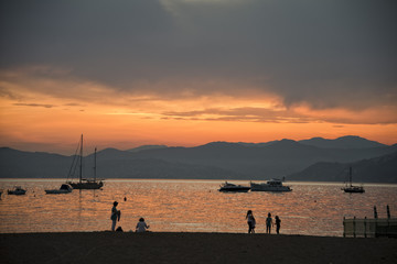 People on sestri levante beach at sunset