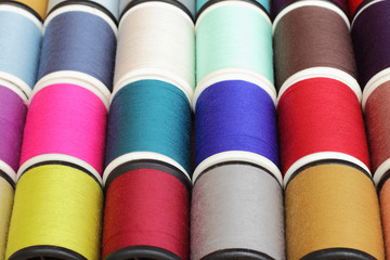 Spools of thread  multicolored background closeup