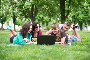 Fototapeta premium Four university students comparing their notes