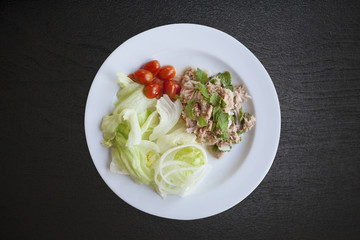 fresh chopped tuna salad with spinach on black wood