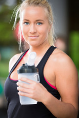 Young blonde woman drink water at crossfit center