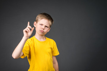 A young cute boy thinking hard.
