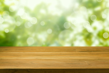 Wooden table over green bokeh background
