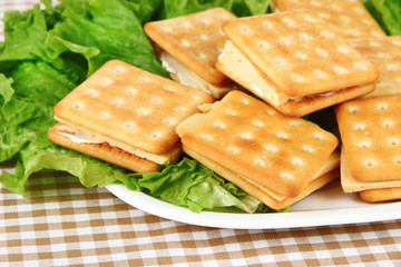 Sandwich crackers with cheese on tablecloth