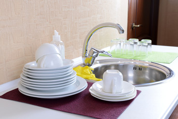 Dishes drying near  metal sink