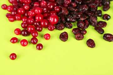 Fresh and dry cranberry on wooden table close-up