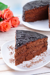 Delicious chocolate cake on plate on table on light background
