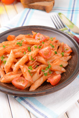 Pasta with tomato sauce on plate on table close-up