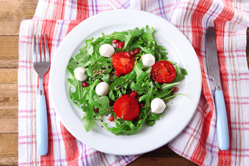 Green salad made with  arugula, tomatoes, cheese mozzarella