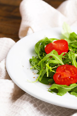 Green salad made with  arugula, tomatoes and sesame