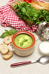 Tasty soup in saucepan on tablecloth, close up