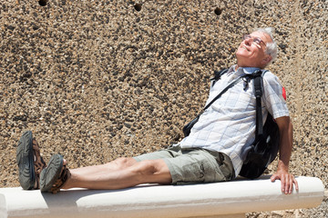 Senior man backpacker resting outdoors