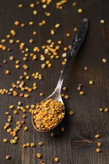 Spice  pollen in spoon on wooden background